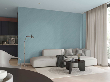Modernes Wohnzimmer mit Sofagarnitur, rundem Couchtisch, eleganter Stehlampe und ozeanblauer Wand